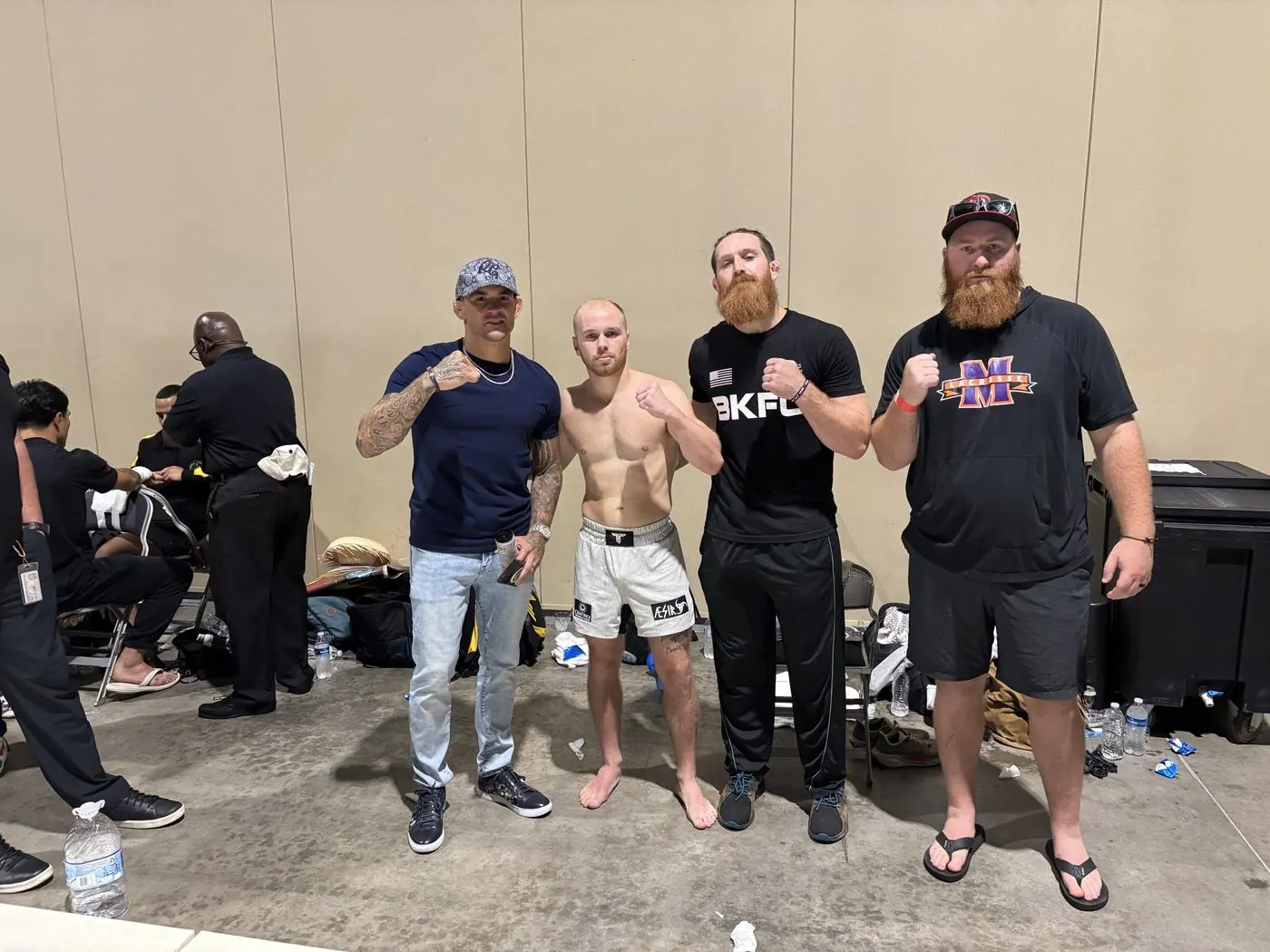 An Aesir fighter and his corner backstage with Dustin Poirier
