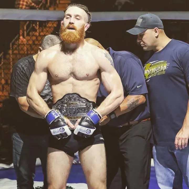 Chris with his championship belt and corner team