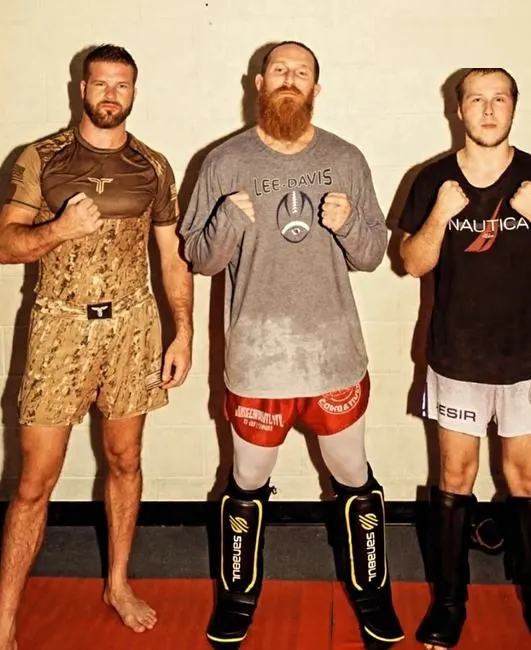 Coach Chris Simpson with two of his fighters before a fight