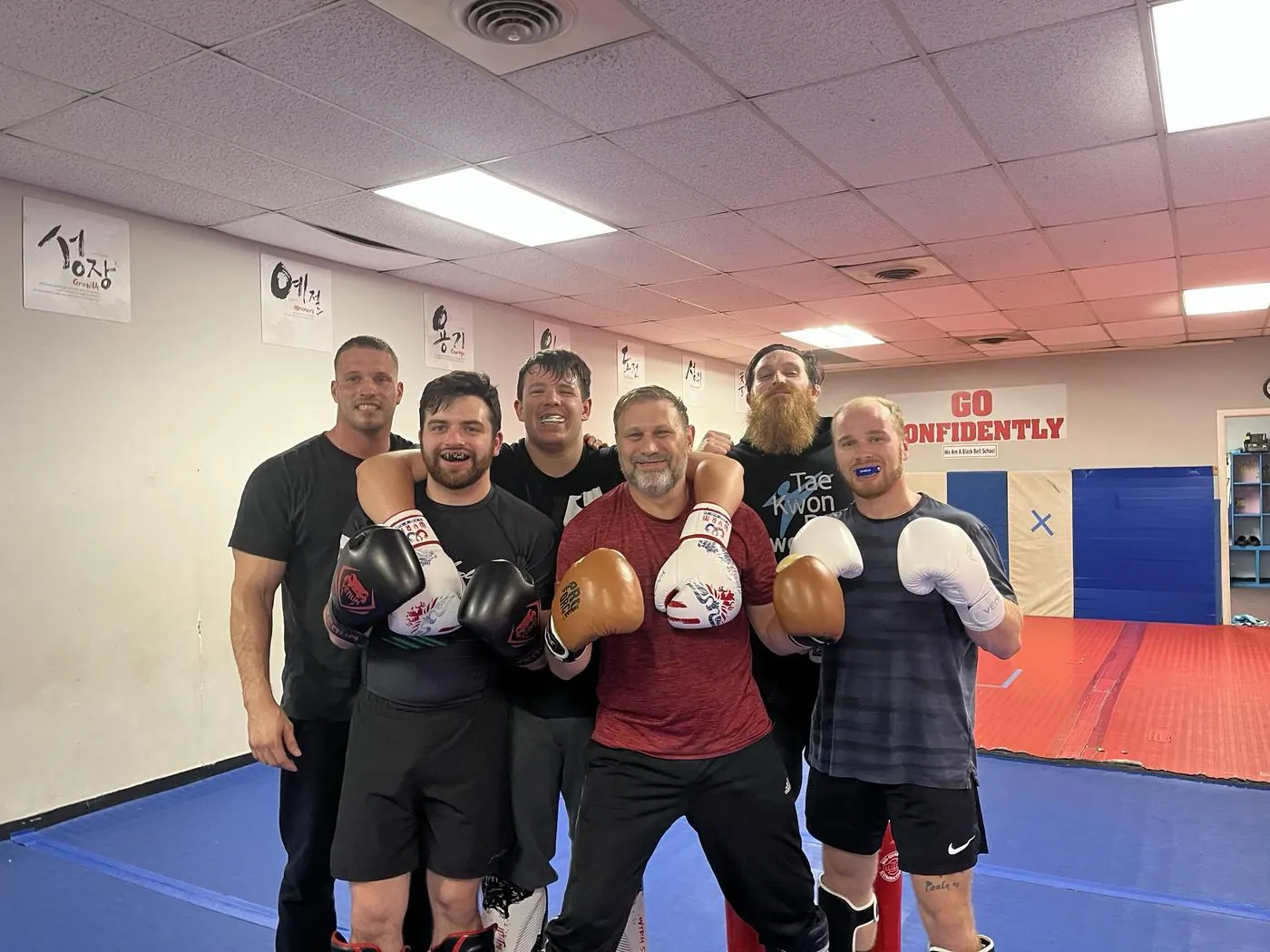 Aesir members smiling together after a sparring session